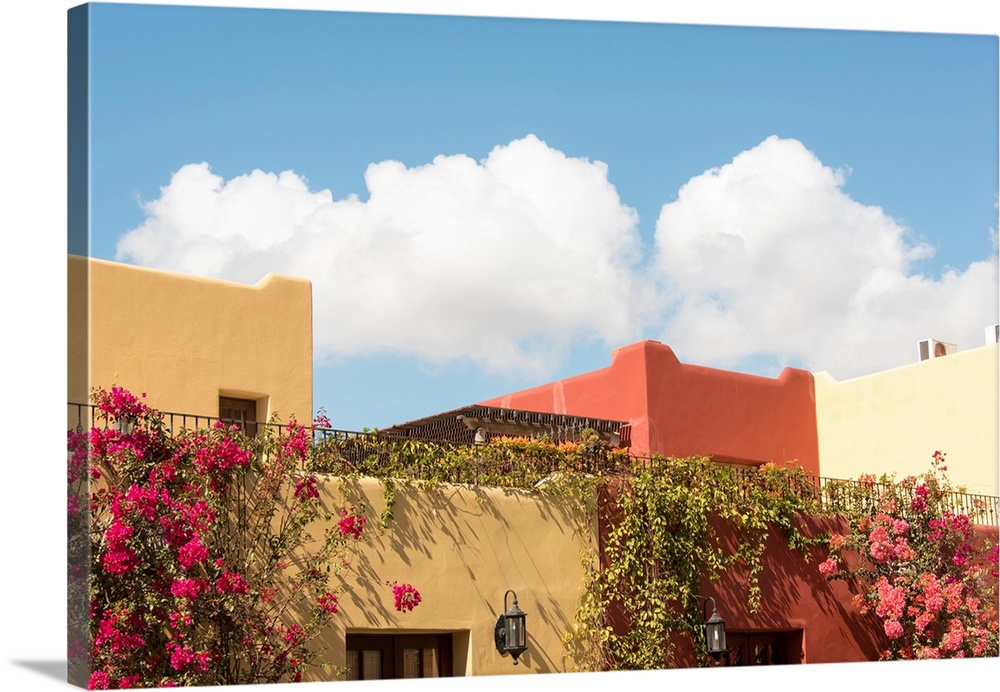 Mexico, Baja California Sur, Loreto Bay. Golf Resort and Spa buildings with bouganveillia and clouds.