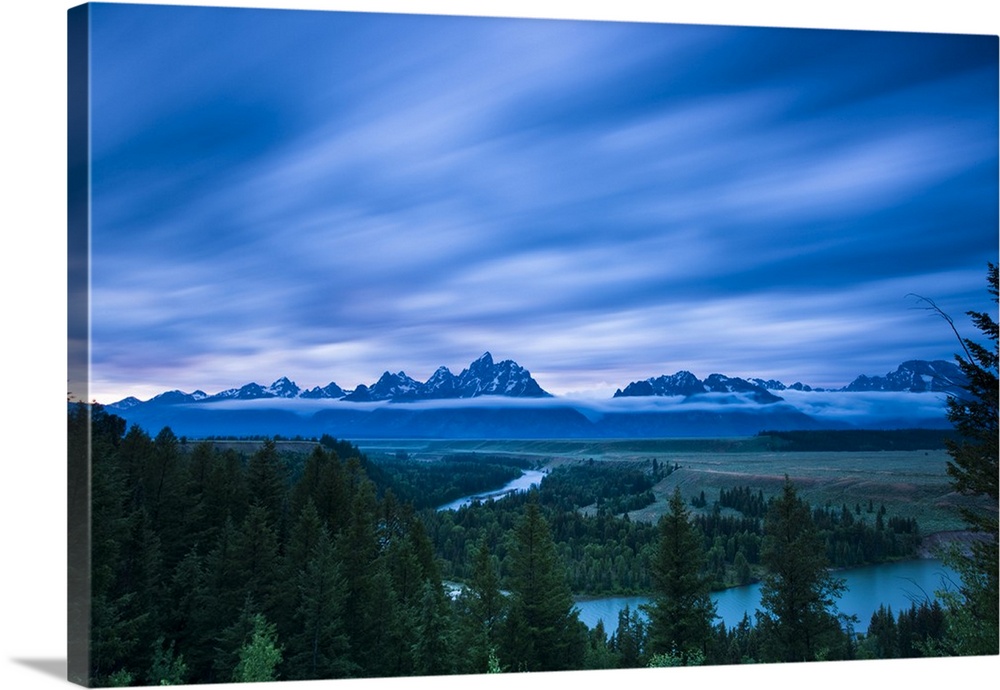 Clouds illuminated with red light above the Grand Teton mountains seen from the Snake River lookout at sunset, Grand Teton...