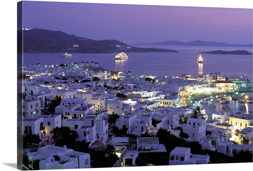 Europe, Greece, Cyclades Islands, Mykonos. Evening view of Mykonos town from hillside fort