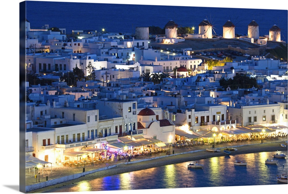 Europe, Greece, Mykonos, Hora. Night view overlooking harbor with illuminated windmills atop hillside. Credit as: Bill You...