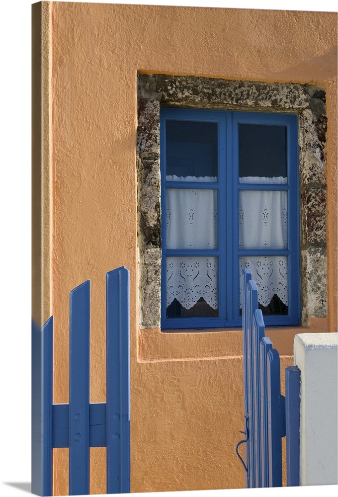 Europe, Greece, Santorini. Open blue gate and window in orange wall.