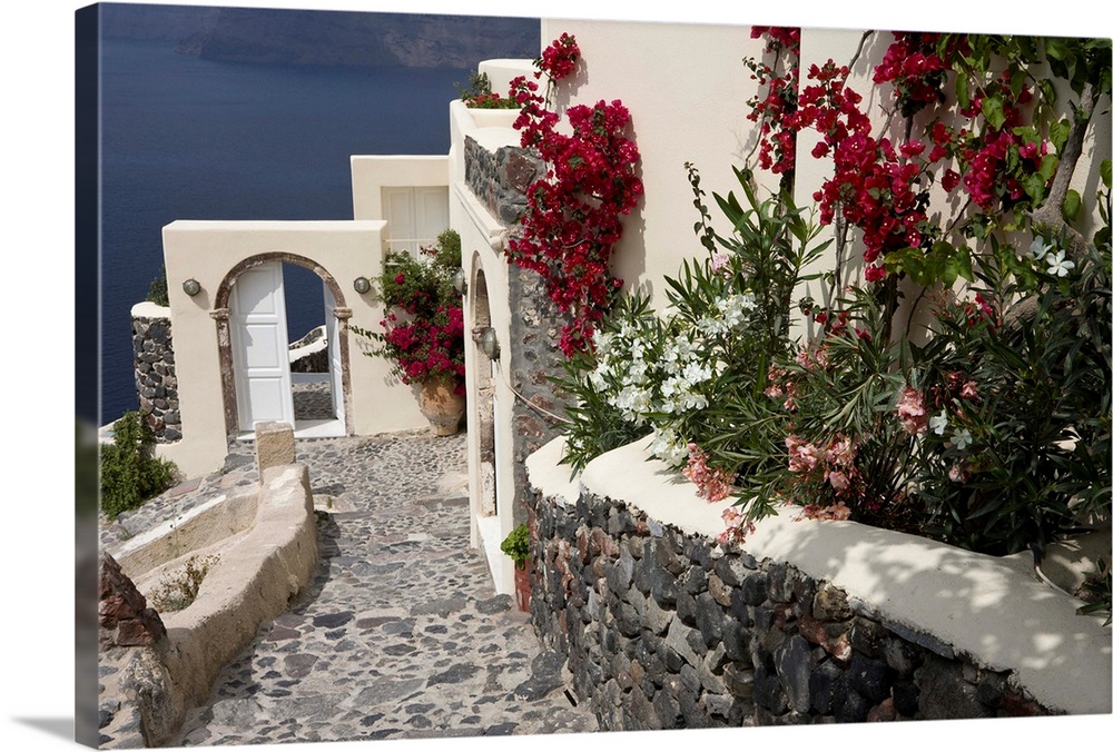Europe, Greece, Santorini, Thira, Oia. Pebbled staircase leading past villa door and flower decorations. Credit as: Bill Y...