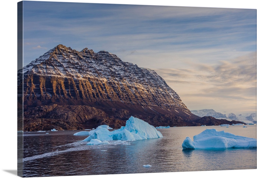 Greenland. Scoresby Sund. Icebergs and deeply eroded mountains.