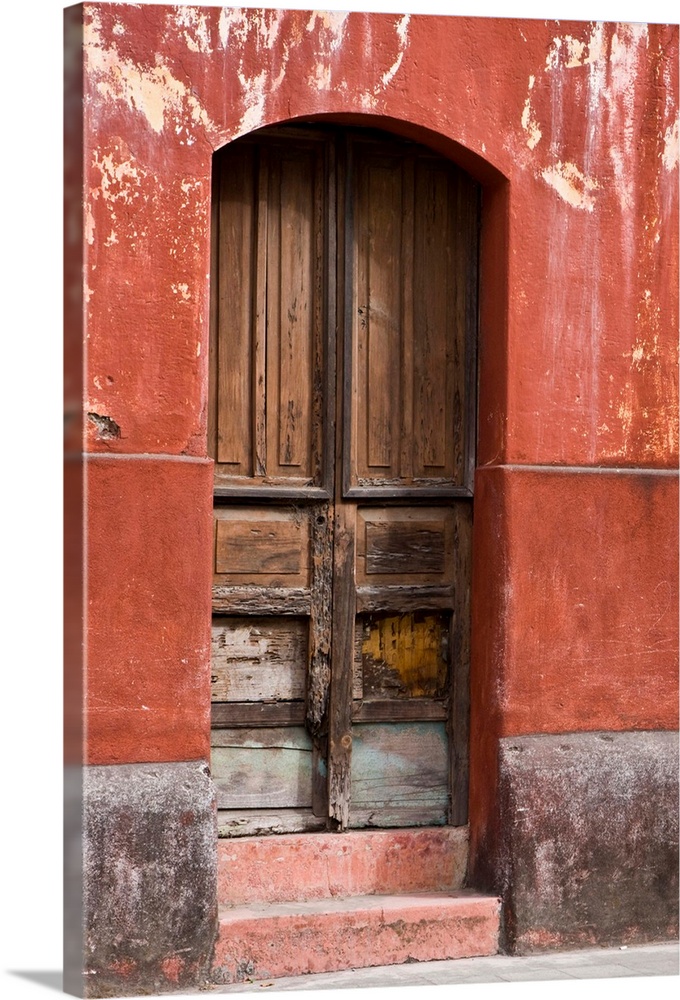 Central America, Guatemala, Antigua.  Exterior wall and wooden door along the streets of Antigua.