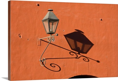 Guatemala, Antigua, lantern with shadow on a colorful wall in the town of Antigua