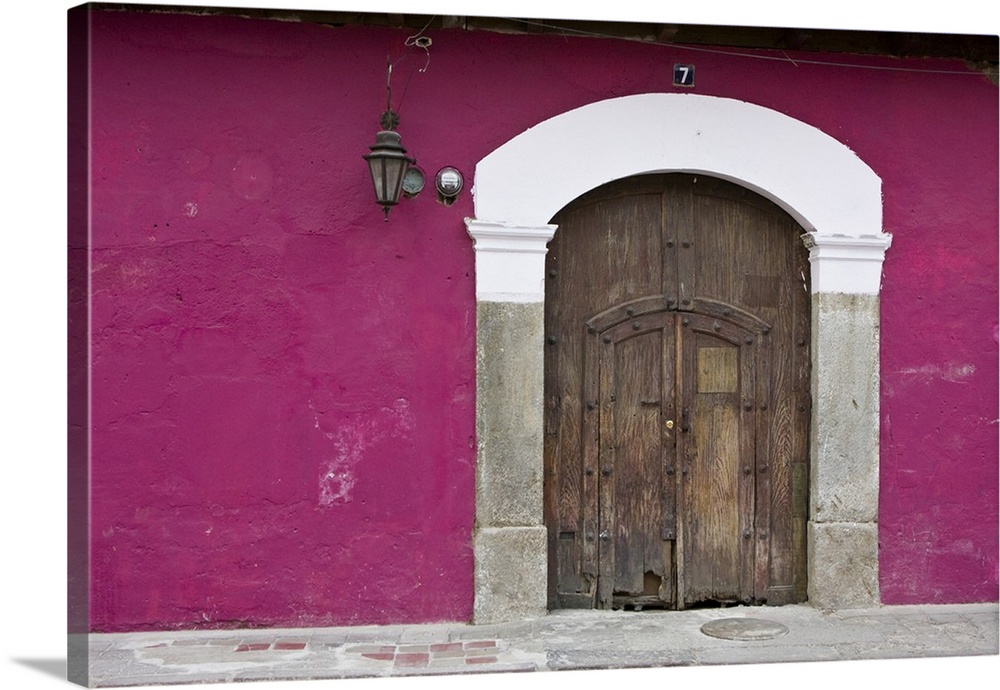 Central America, Guatemala, Antigua.  Ornate wooden doors of home in the town of Antigua.