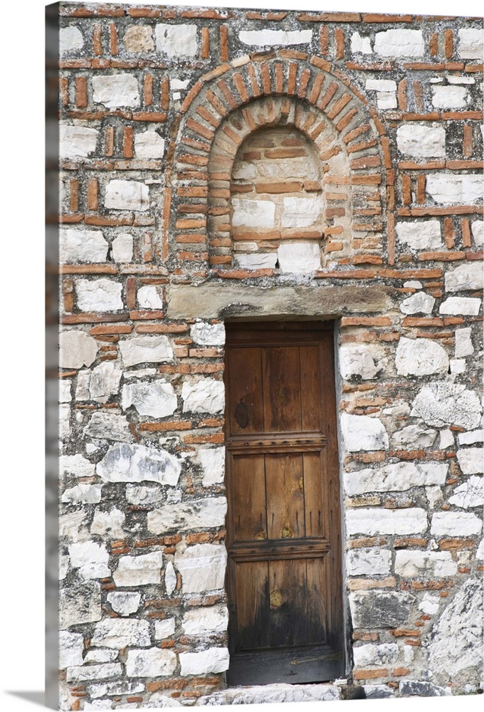 The Hagia Triada Church. Detail of an old wooden door and arched window. Berat upper citadel old walled city. Albania, Bal...