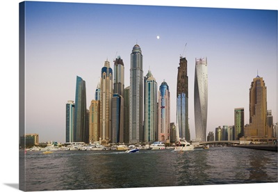 High Rise Buildings Including The Twisted Cayan Tower With Moonrise In Dubai