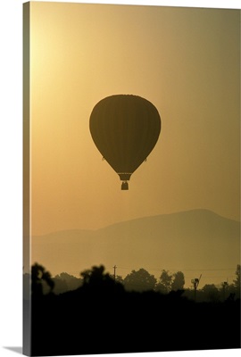 Hot air balloon lifting over Napa valley at sunrise
