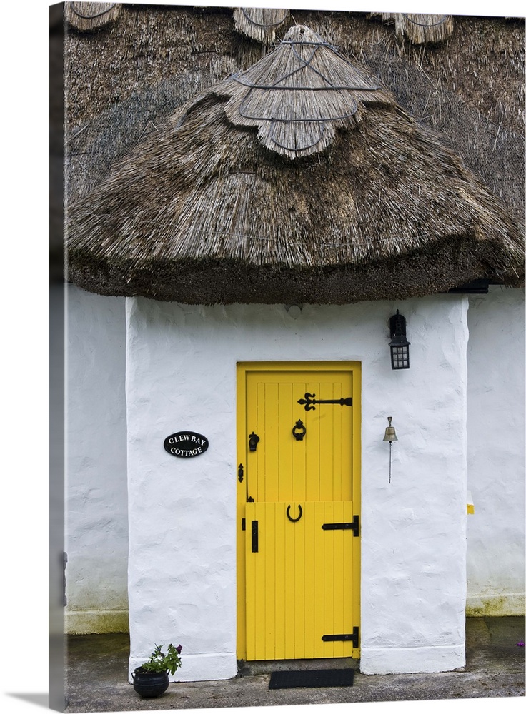 Ireland, Achill Island. Yellow doorway on a thatch roof cottage.