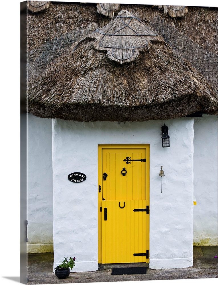 Ireland, Achill Island. Yellow doorway on a thatch roof cottage.