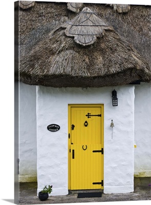 Ireland, Achill Island. Yellow doorway on a thatch roof cottage