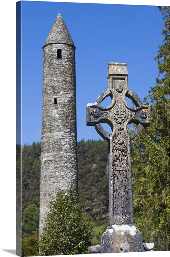 Ireland, County Wicklow, Glendalough, ancient monastic settlement started by St. Kevin, Celtic cross and Round Tower.