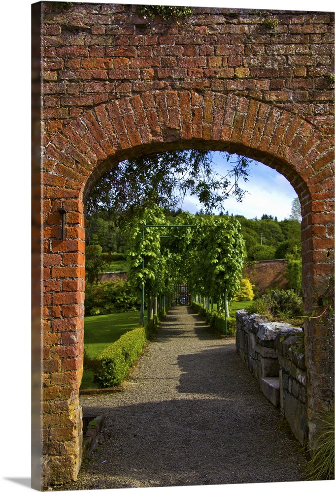In Ireland,the Dromoland Castle Walled Garden path through a brick archway no people