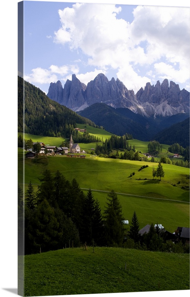 Beautiful isolated lonely church St Maddalena and village in valley  in the Italian Dolomites village of Val Di Funes moun...