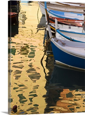 Italy, Camogli, Boats and buildings form abstract reflections on water