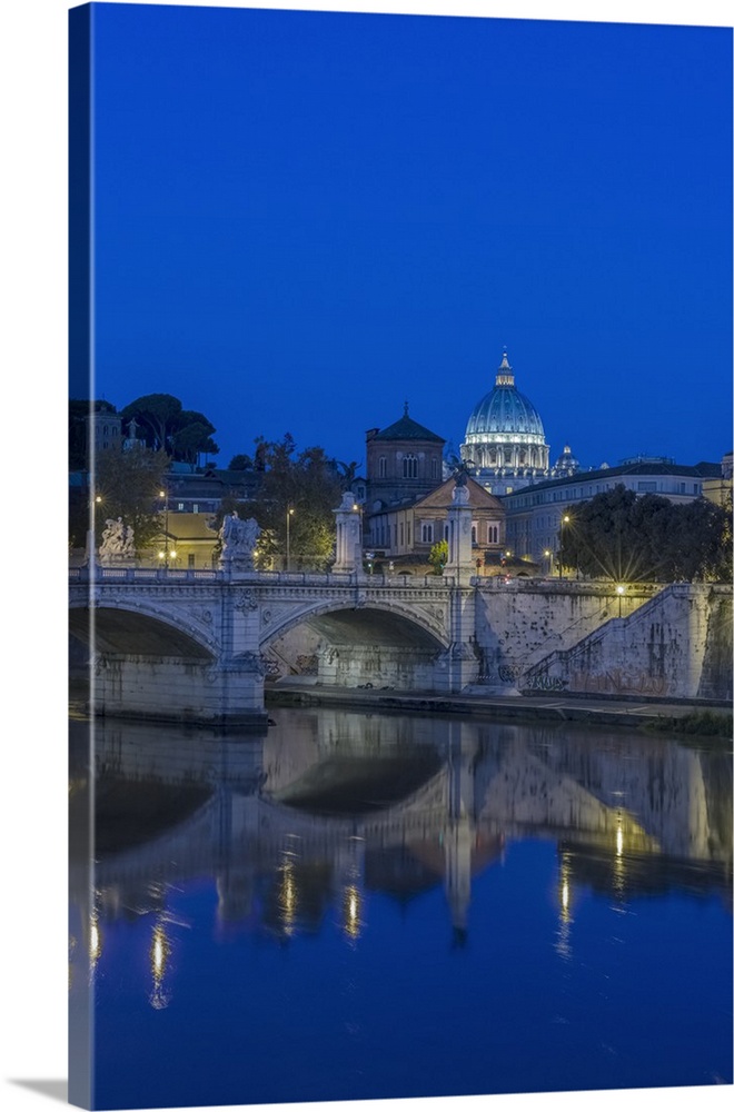 Italy, Rome, Tiber River and Ponte Vittorio Emanuele with St. Peter's Basilica at dawn.