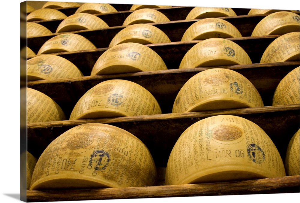 Europe, Italy, Ruberia. Shelves of aging Parmigiano-Reggiano cheese.
