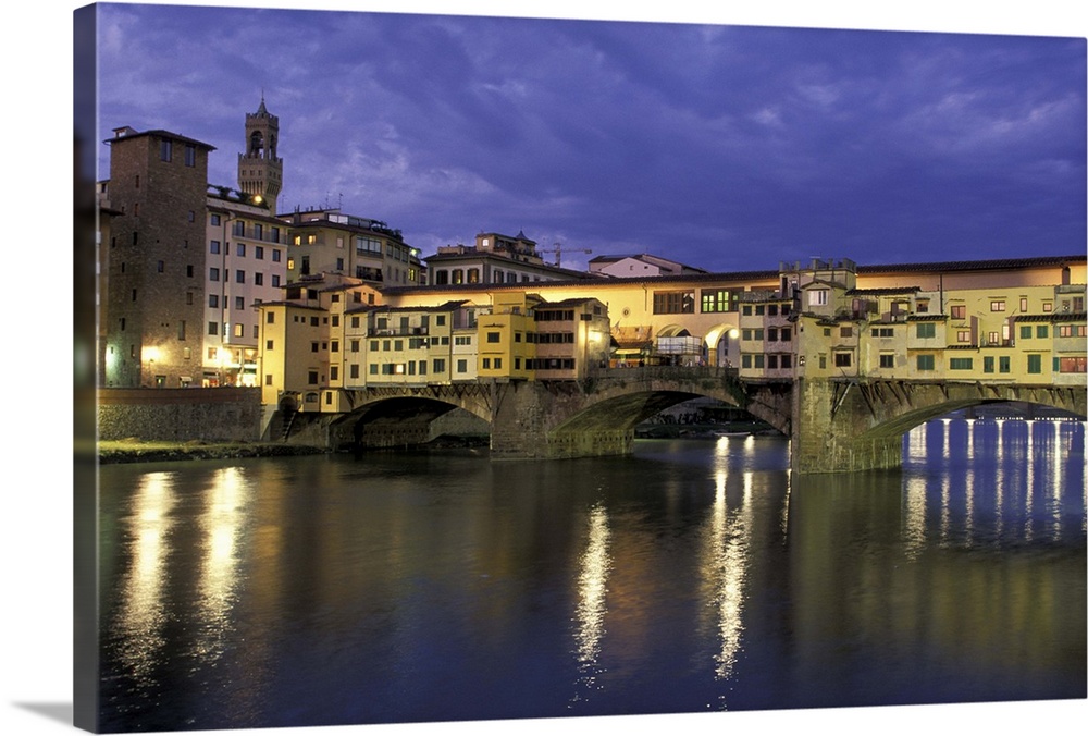 Europe, Italy, Tuscany, Florence. Evening view of Ponte Vecchio from Arno River