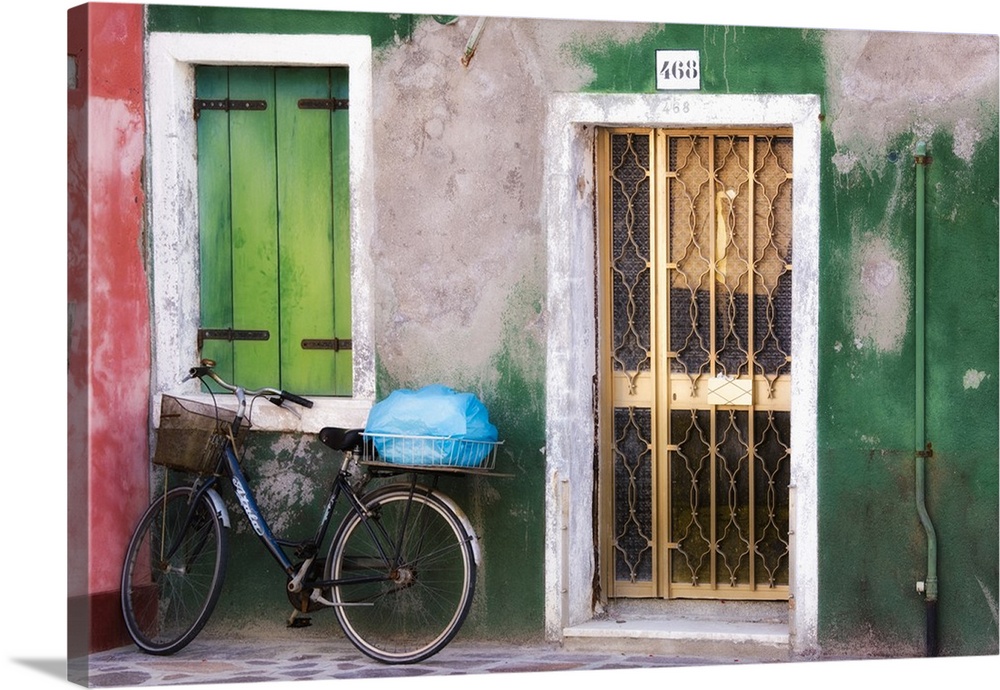 Italy, Venice. An old bicycle leans against a weathered house on the island of Burano.