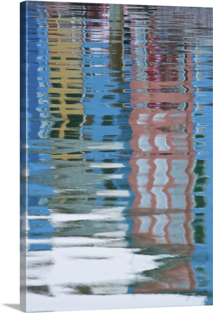 Italy, Venice, Burano. Multicolored houses reflected in water.