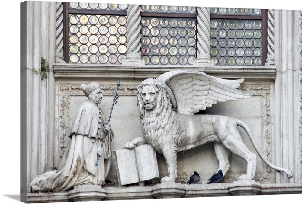 Europe, Italy, Venice. Statue of a winged lion and the Doge on the Doge's Palace.