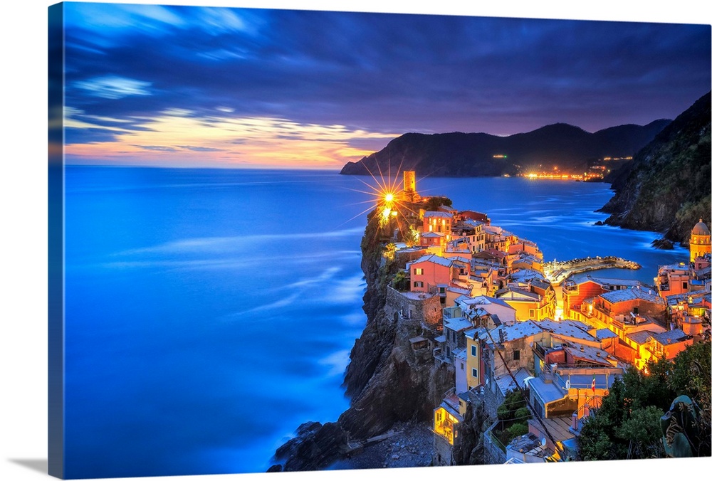 Italy, Vernazza. Overview of coastal town at sunset. Credit: Jim Nilsen