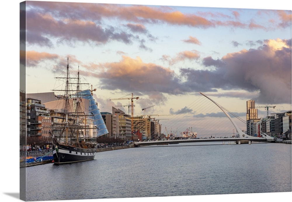 Jeanie Johnston Tall Ship and Samuel Beckett Bridge over the River Liffey in downtown Dublin, Ireland