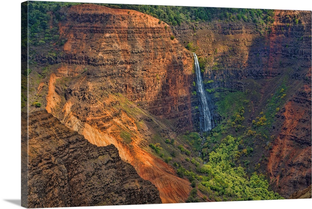 Kauai Hawaii, scenic Waimea Canyon State Park, Red cliffs from above canyon with distant waterfall