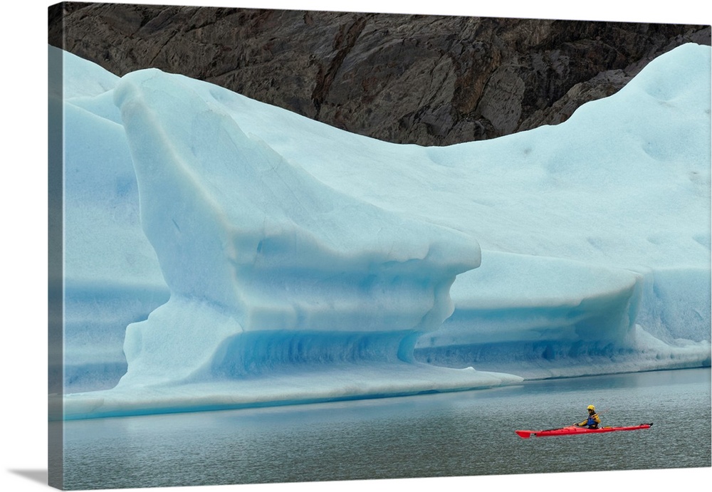 Kayaker's exploring Grey Lake amid large iceberg, Torres del Paine National Park, Chile, South America, Patagonia.