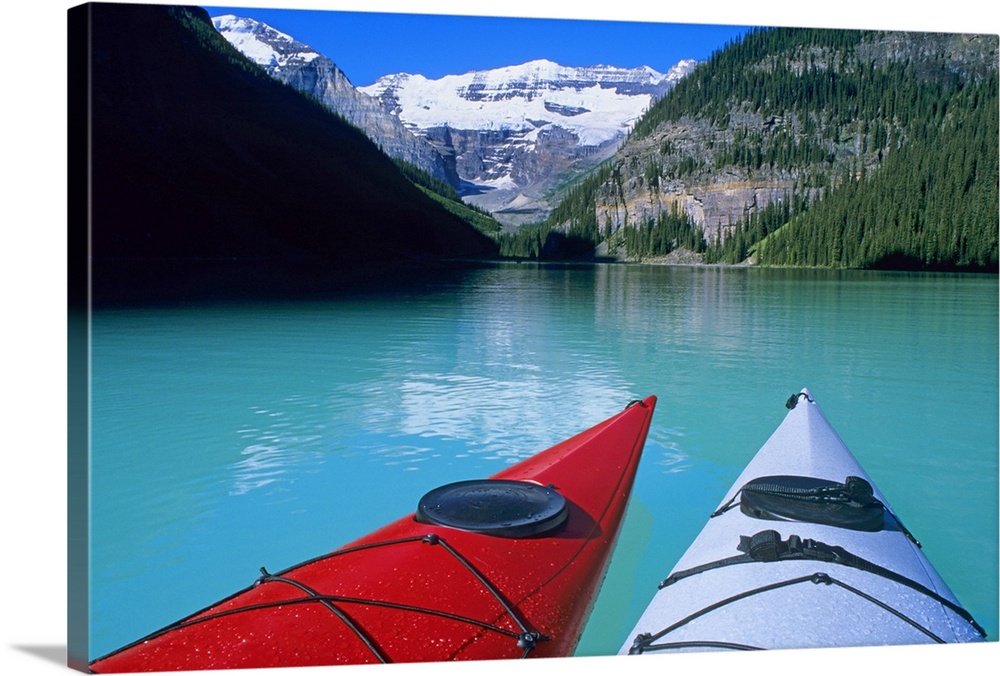 Kayaks on Lake Louise below Mount Victoria in the Canadian Rockies; Banff National Park; Alberta, Canada