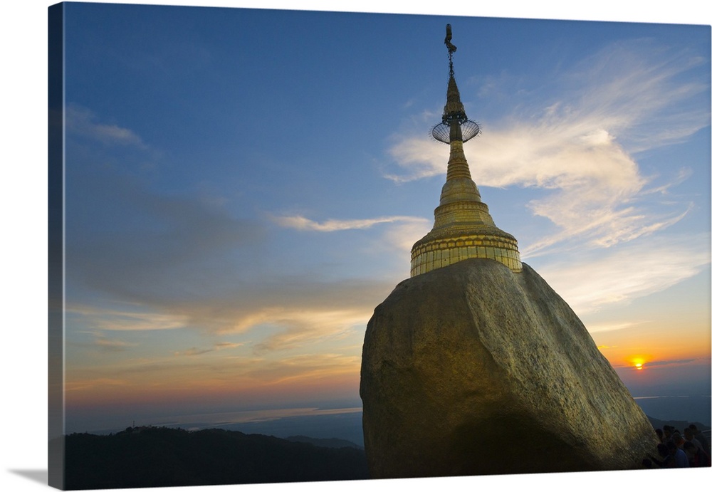 Kyaiktiyo Pagoda at sunset, a small pagoda built on the top of a granite boulder covered with gold leaves pasted on by dev...