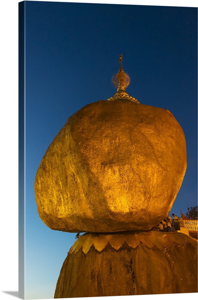 Kyaiktiyo Pagoda at sunset, a small pagoda built on the top of a granite boulder covered with gold leaves pasted on by dev...