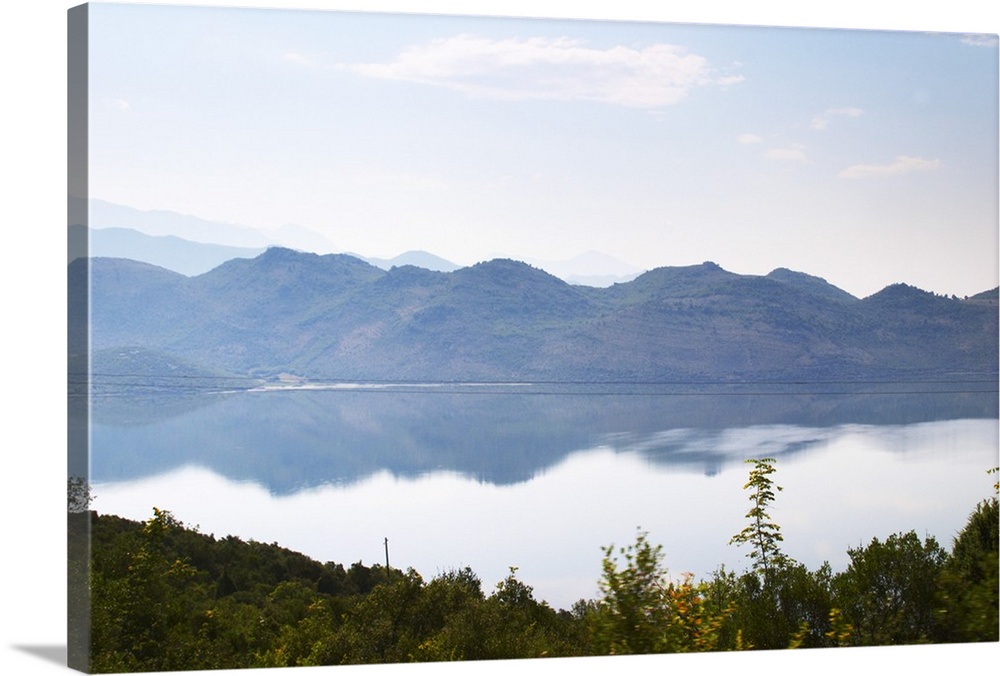 View over the vast lake and marshland Skadarsko Jezero on the border between Montenegro and Albania. Mountains in Albania ...
