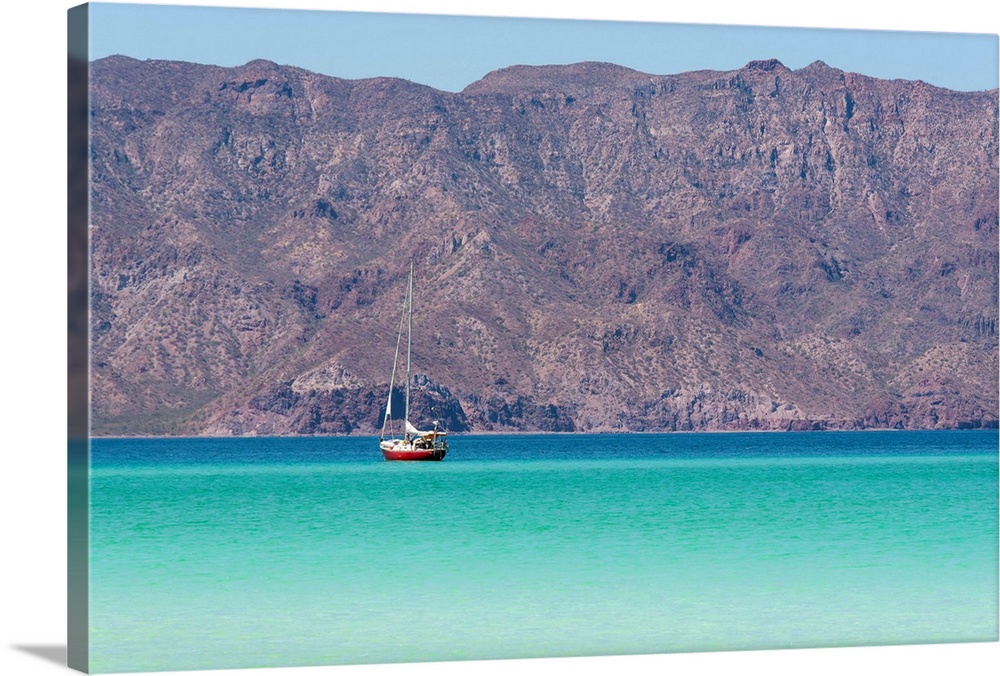 Mexico, Baja California Sur, Sea of Cortez, Loreto Bay. Lone sailboat on flat calm water with Sierra de la Giganta beyond.