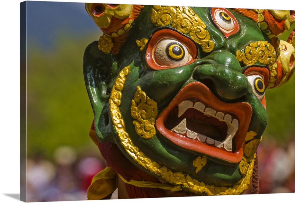 Mask of dancer at religious festivity with many visitors, Paro Tsechu, Bhutan, Asia.