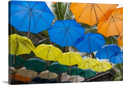 Mauritius, Port Louis, Caudan waterfront area with colorful umbrella covering