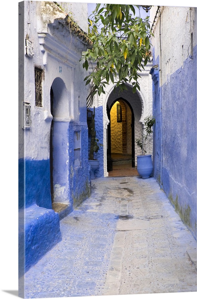 Morocco, Chaouen. Narrow street lined with blue buildings.