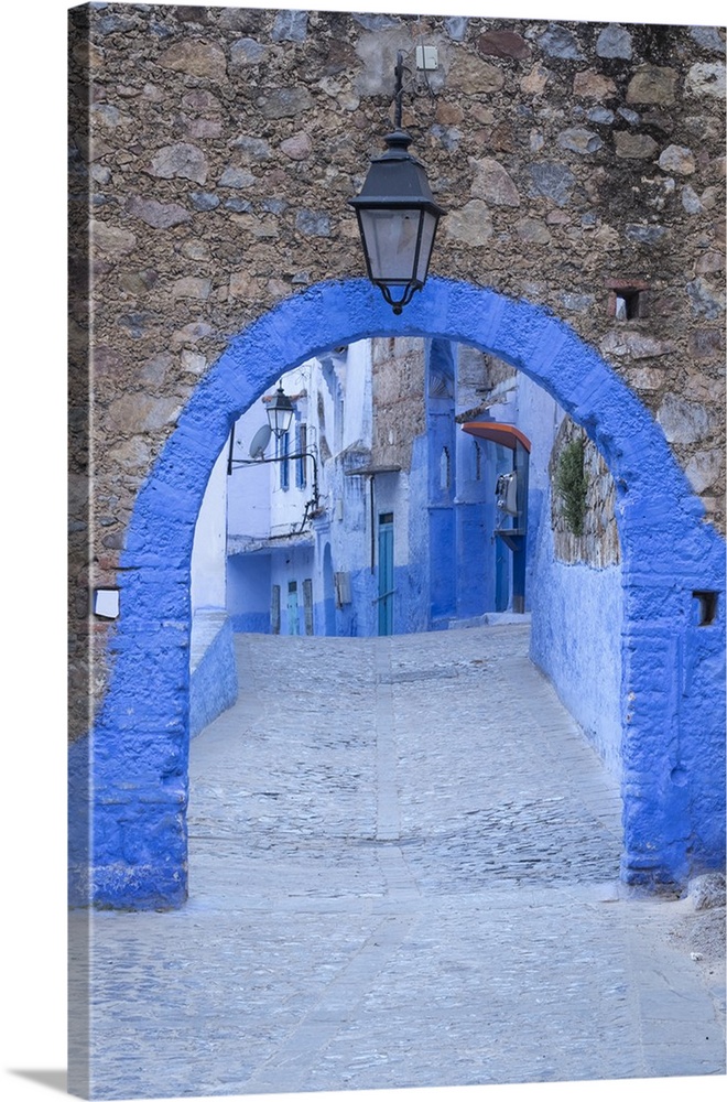Morocco, Chefchaouen. A blue arch and quiet street entering the medina of the village.