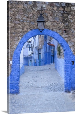 Morocco, Chefchaouen, A blue arch and quiet street entering the medina of the village