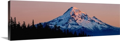 Mt Hood reflects the light from the setting sun in the Cascades Range, Oregon