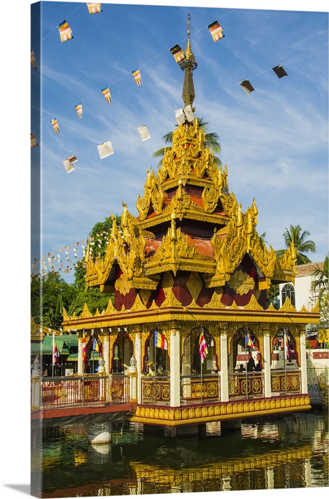 Myanmar. Yangon. Kyay Thone Pagoda. Buddhist flags flying in the breeze.