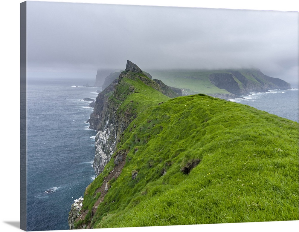 The island Mykines, seen from Mykinesholmur, part of the Faroe Islands in the North Atlantic. Europe, Northern Europe, Den...