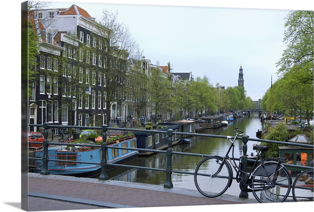 Europe, Netherlands, Holland, Amsterdam, Along the Prinsengracht canal with the Westerkerk in the distance.
