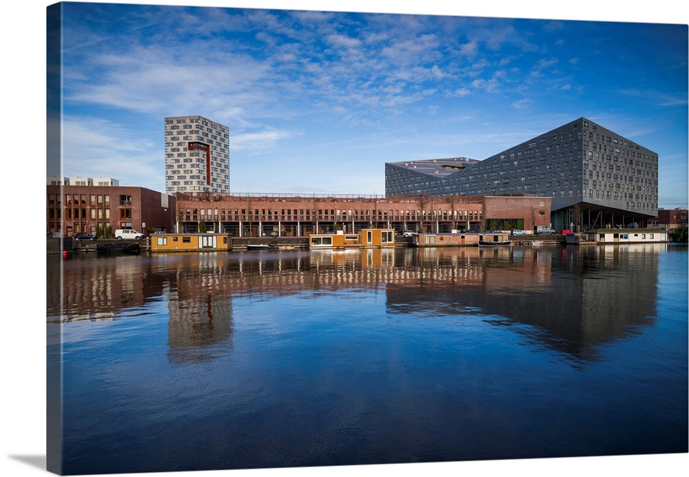 Netherlands, Amsterdam, Eastern Docklands, Spoorweg-bssin with The Whale Building and renovated docklands area.