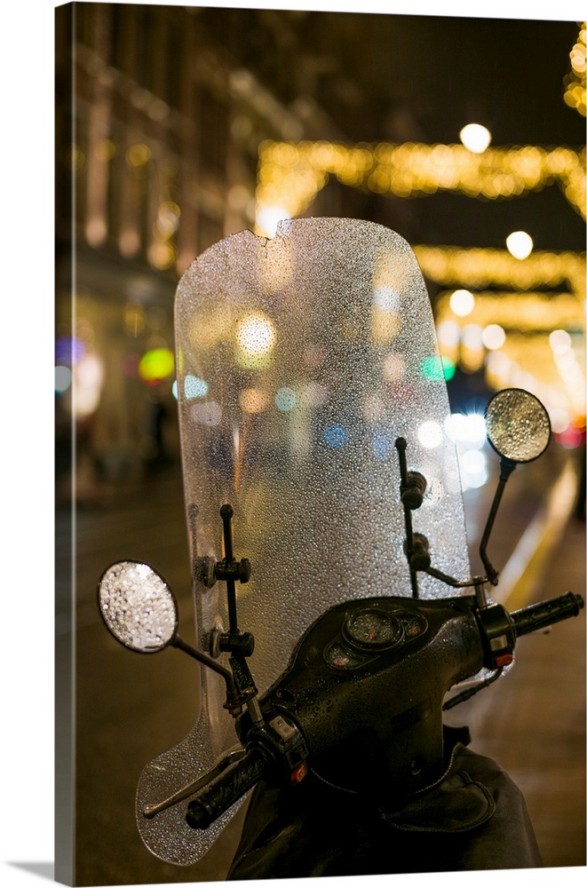 Netherlands, Amsterdam, Utrechtstraat street, motorbike and Holiday decorations, evening.