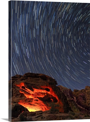 Nevada, Valley Of Fire State Park, Star Trails And Campfire Glowing In Sandstone Rocks