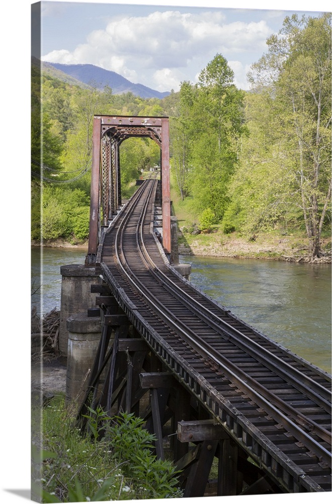 USA, North Carolina. Abandoned railroad trestle spans river.