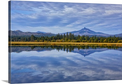 Oregon. Clouds reflect in small lake at Black Butte Ranch