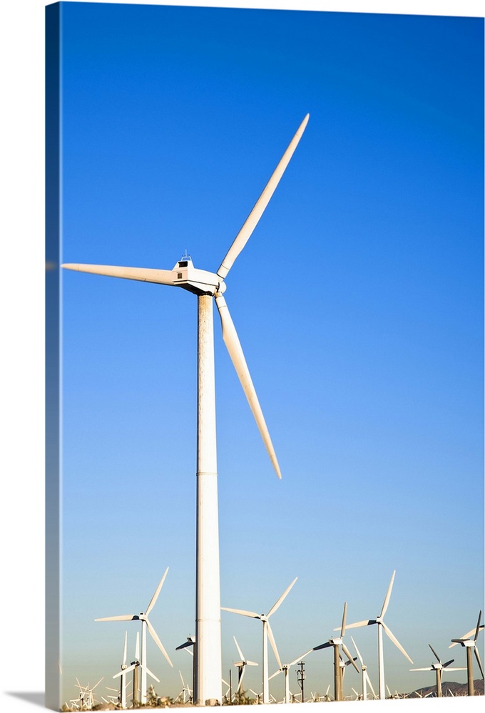 Palm Springs, California. View of wind turbines in the desert under a clear blue sky.